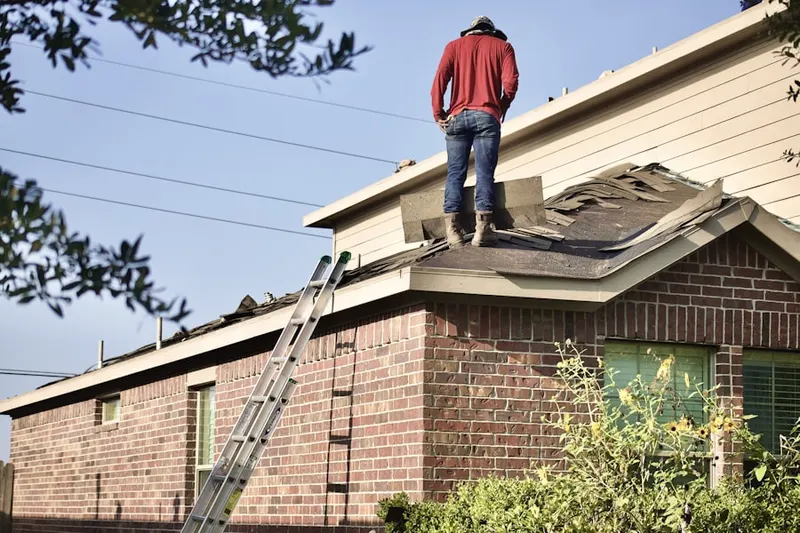 Professional roofer working on a residential roof in Northfield Woods